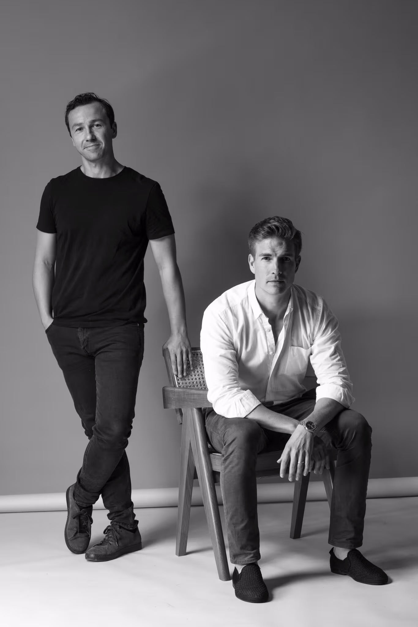 The two Abate founders, Kristian and Leo. One standing and one sitting on a stool, against a plain background