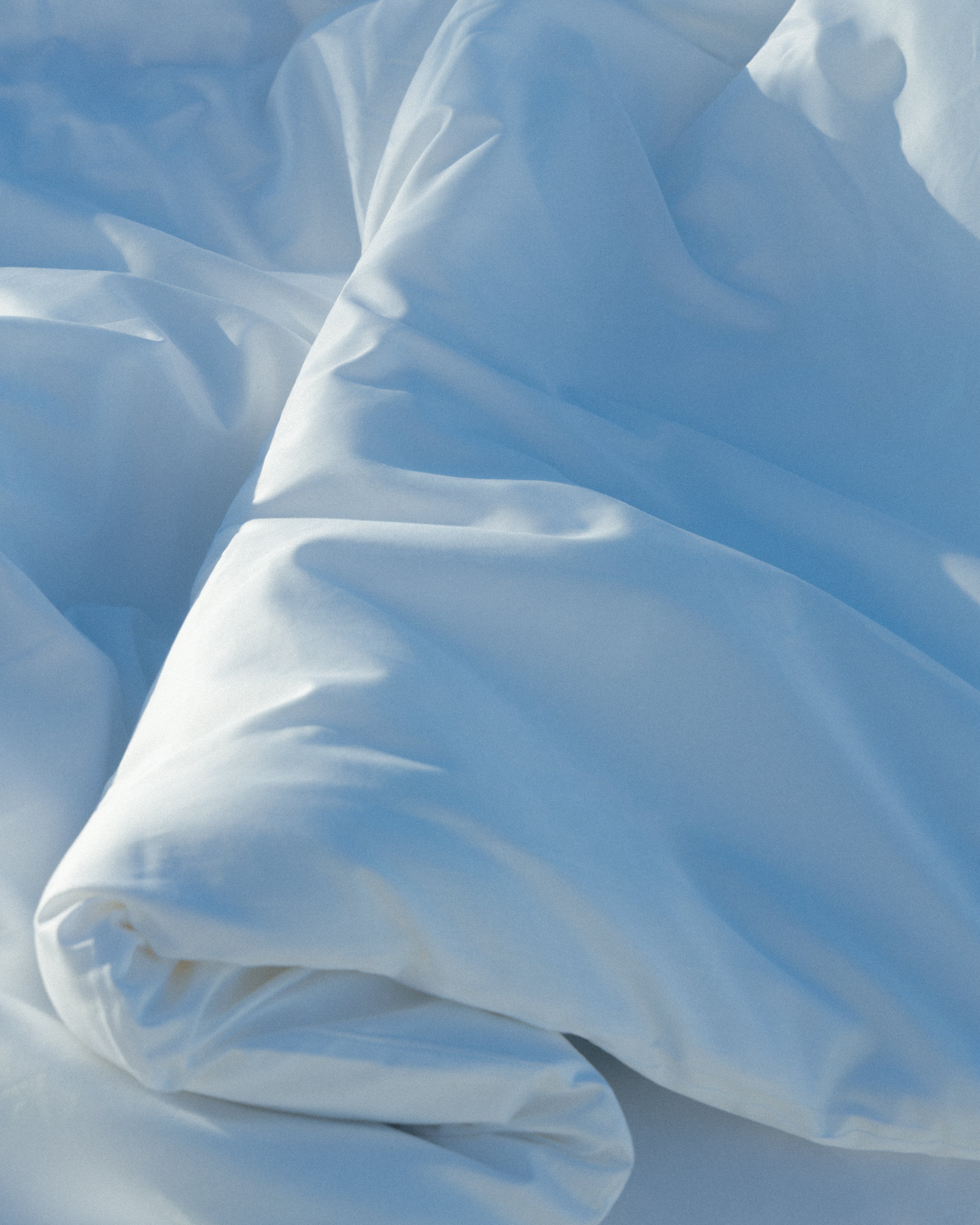 Close-up of light blue fabric with folds