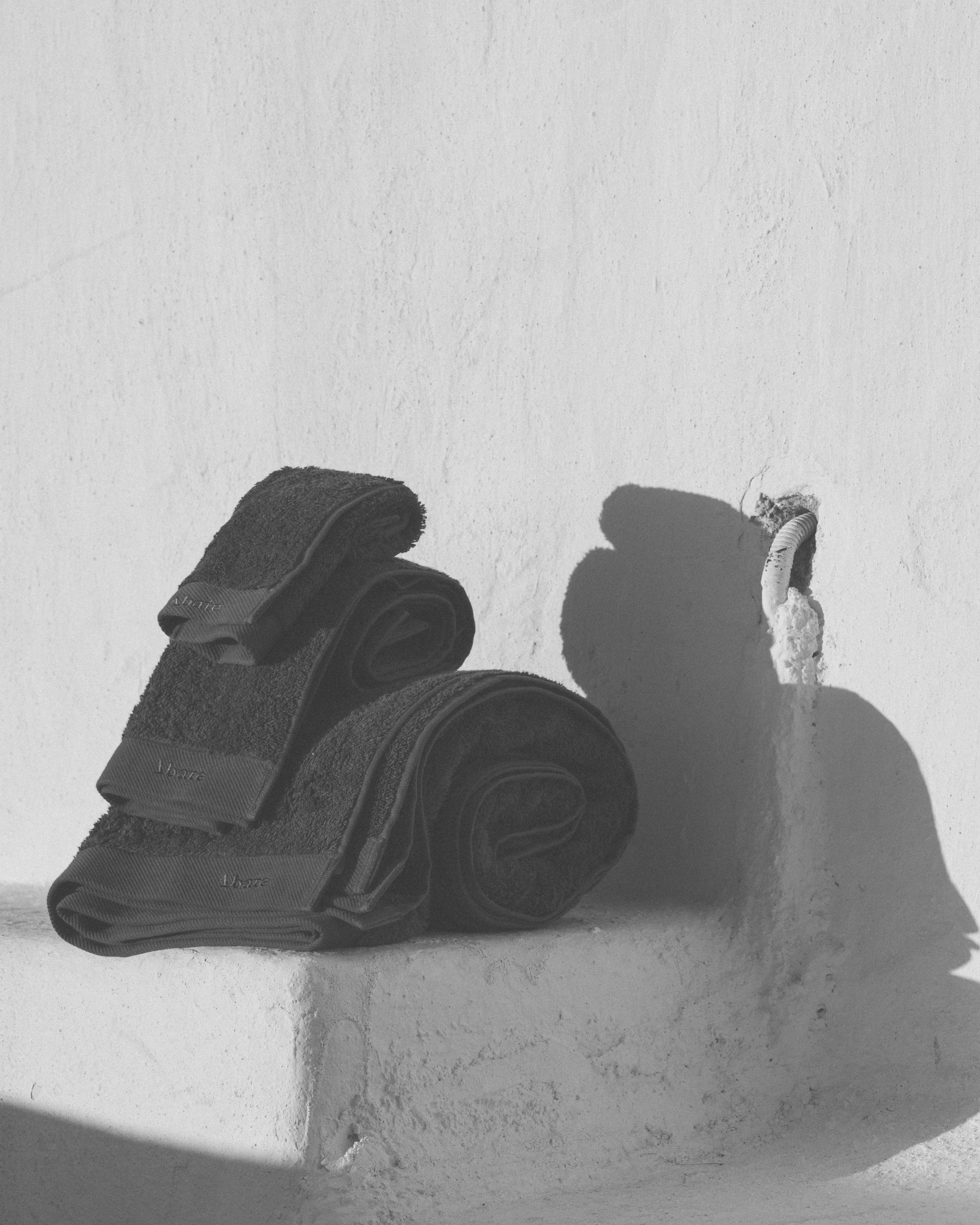 Black leather gloves on a textured white surface